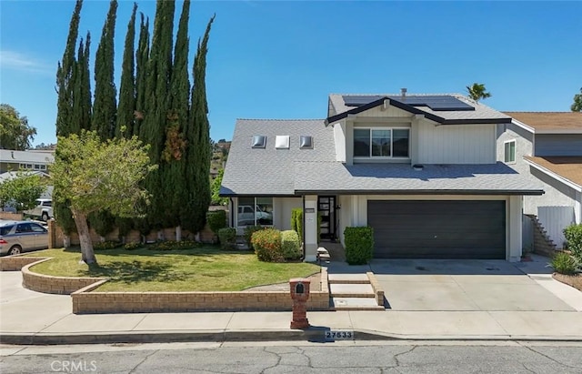 27533 Caraway Ln, Saugus, CA 91350 - view of front facade with driveway, solar panels, a front yard, and a garage
