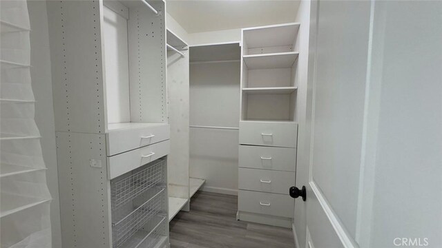 27533 Caraway Ln, Saugus, CA 91350 - walk in closet featuring wood finished floors