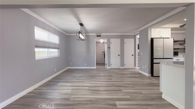 27533 Caraway Ln, Saugus, CA 91350 - unfurnished dining area with ornamental molding and light wood-style floors