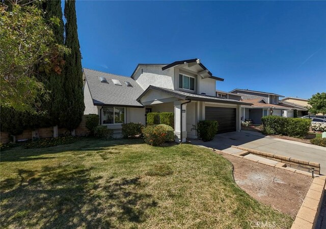 27533 Caraway Ln, Saugus, CA 91350 - view of front facade with driveway, stucco siding, a front yard, and a garage