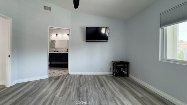 27533 Caraway Ln, Saugus, CA 91350 - unfurnished bedroom featuring vaulted ceiling, wood finished floors, ensuite bathroom, and a ceiling fan