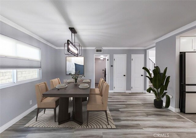 27533 Caraway Ln, Saugus, CA 91350 - dining space featuring light wood finished floors and ornamental molding