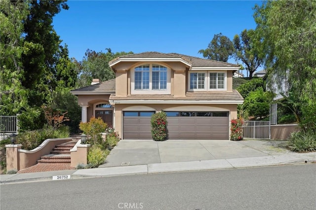 26752 Devonshire Rd, Laguna Hills, CA 92653 - traditional home featuring stucco siding, a garage, fence, concrete driveway, and a tile roof