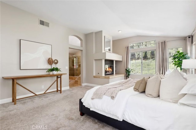 26752 Devonshire Rd, Laguna Hills, CA 92653 - bedroom with vaulted ceiling, arched walkways, carpet floors, a multi sided fireplace, and baseboards