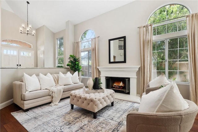 26752 Devonshire Rd, Laguna Hills, CA 92653 - living area with a chandelier, wood finished floors, a glass covered fireplace, baseboards, and vaulted ceiling