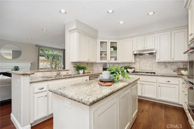 26752 Devonshire Rd, Laguna Hills, CA 92653 - kitchen with a sink, under cabinet range hood, white cabinets, backsplash, and recessed lighting