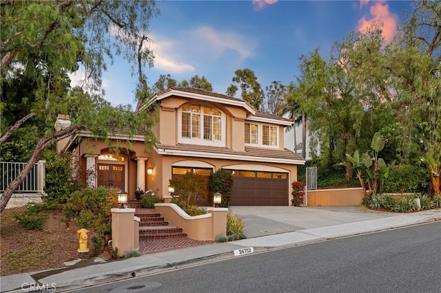 26752 Devonshire Rd, Laguna Hills, CA 92653 - view of front facade with stucco siding, a garage, and concrete driveway