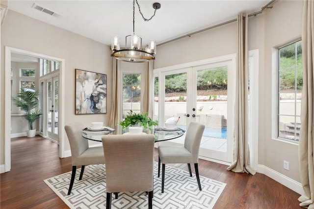 26752 Devonshire Rd, Laguna Hills, CA 92653 - dining room featuring french doors, a chandelier, dark wood-type flooring, and baseboards