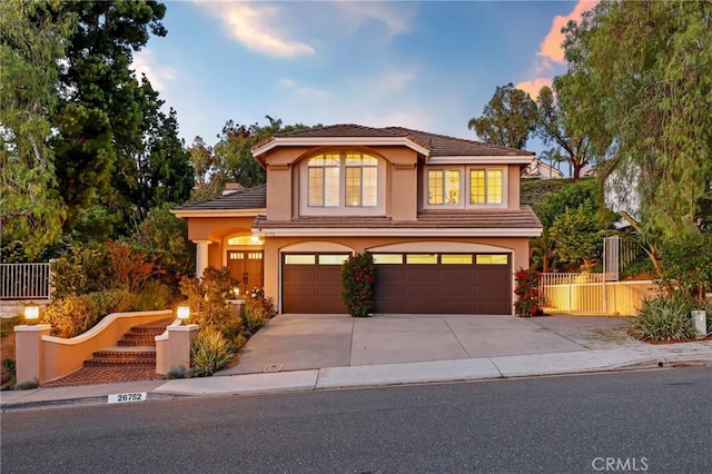 26752 Devonshire Rd, Laguna Hills, CA 92653 - view of front facade featuring a garage, concrete driveway, stucco siding, and fence