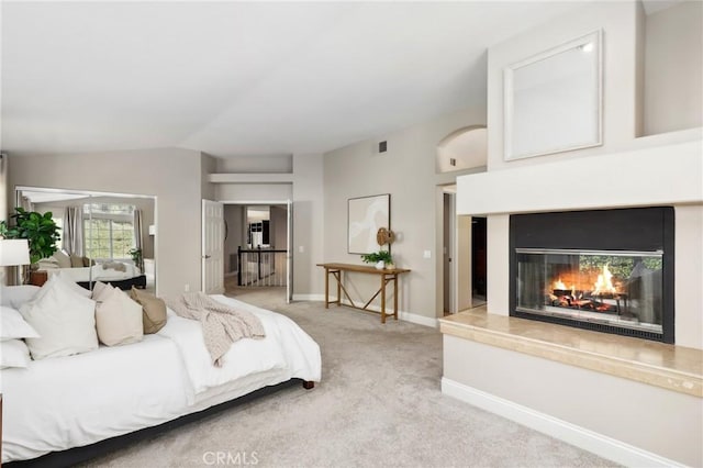 26752 Devonshire Rd, Laguna Hills, CA 92653 - bedroom featuring light carpet, vaulted ceiling, a warm lit fireplace, and baseboards
