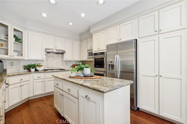 26752 Devonshire Rd, Laguna Hills, CA 92653 - kitchen featuring stainless steel appliances, under cabinet range hood, white cabinets, recessed lighting, and glass insert cabinets