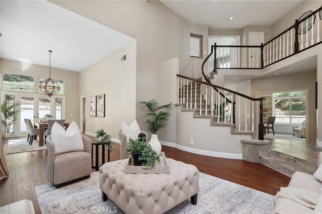 26752 Devonshire Rd, Laguna Hills, CA 92653 - living area with a high ceiling, a chandelier, stairway, wood finished floors, and baseboards