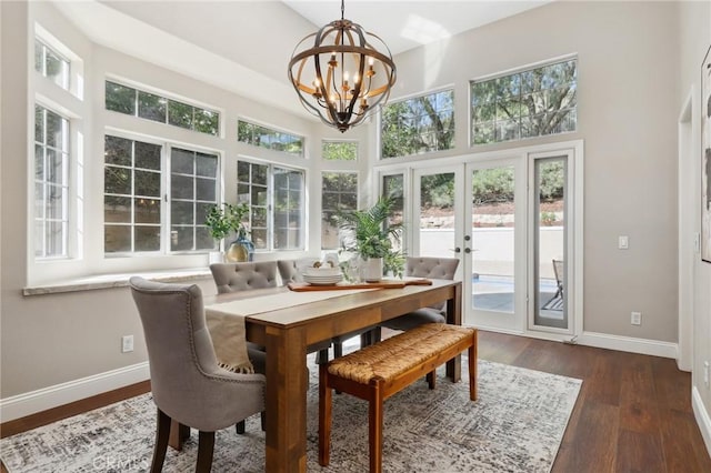 26752 Devonshire Rd, Laguna Hills, CA 92653 - dining area with a chandelier, baseboards, dark wood-type flooring, french doors, and a towering ceiling