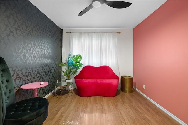 15015 Sherman Way Unit 314, Van Nuys, CA 91405 - living area with an accent wall, wallpapered walls, ceiling fan, wood finished floors, and baseboards