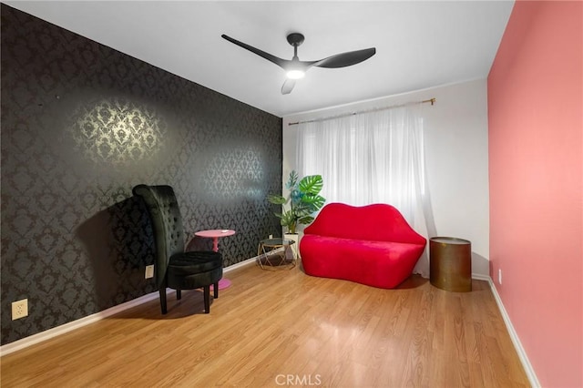15015 Sherman Way Unit 314, Van Nuys, CA 91405 - sitting room with wallpapered walls, wood finished floors, ceiling fan, and baseboards