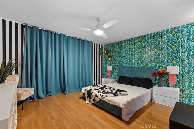 15015 Sherman Way Unit 314, Van Nuys, CA 91405 - bedroom featuring wallpapered walls, light wood-type flooring, an accent wall, and a ceiling fan