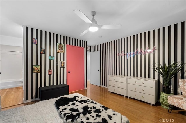 15015 Sherman Way Unit 314, Van Nuys, CA 91405 - bedroom with wood finished floors, wallpapered walls, and a ceiling fan