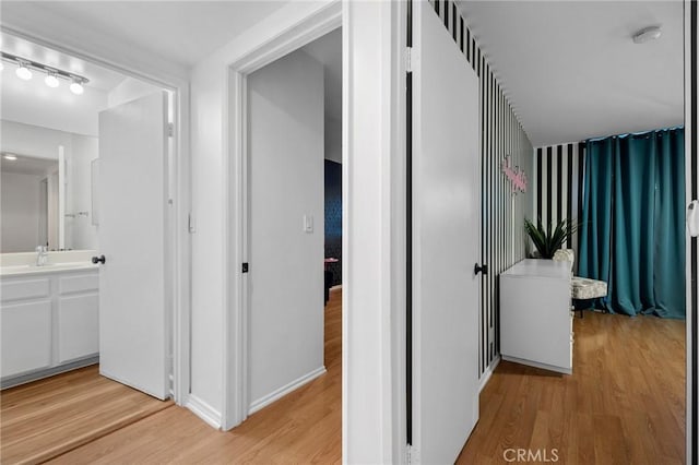 15015 Sherman Way Unit 314, Van Nuys, CA 91405 - hall with light wood-type flooring and a sink