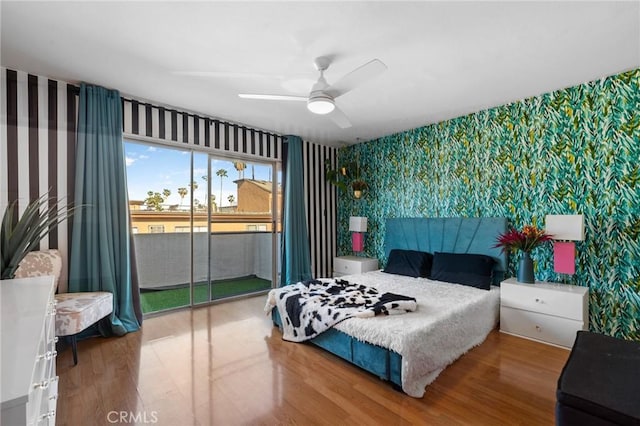 15015 Sherman Way Unit 314, Van Nuys, CA 91405 - bedroom with wallpapered walls, access to outside, wood finished floors, an accent wall, and a ceiling fan