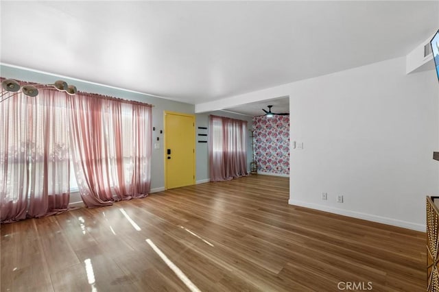 15015 Sherman Way Unit 314, Van Nuys, CA 91405 - unfurnished living room with baseboards, wood finished floors, and a ceiling fan