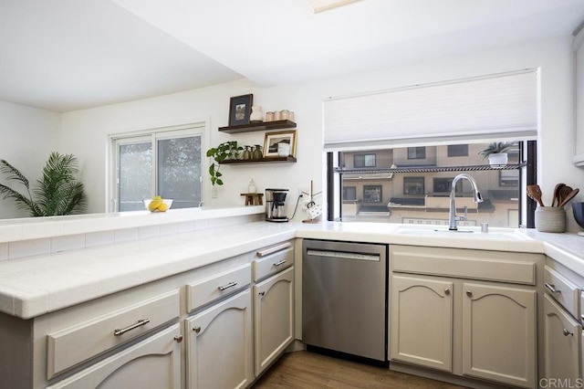 2506 Woodlands Way, Oceanside, CA 92054 - kitchen with stainless steel dishwasher, a sink, a peninsula, open shelves, and tile counters