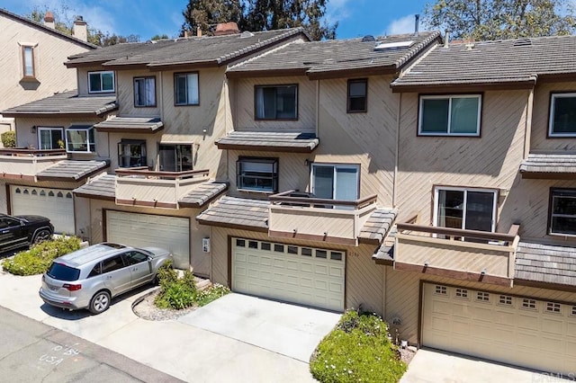 2506 Woodlands Way, Oceanside, CA 92054 - multi unit property featuring an attached garage, driveway, a balcony, and stucco siding
