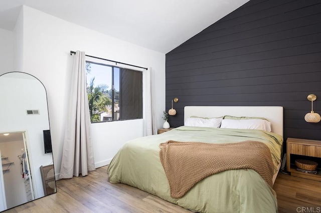 2506 Woodlands Way, Oceanside, CA 92054 - bedroom with wood finished floors, wooden walls, and high vaulted ceiling