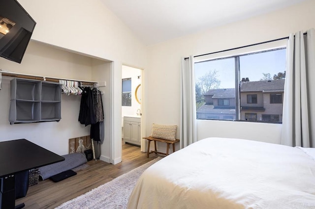 2506 Woodlands Way, Oceanside, CA 92054 - bedroom featuring wood finished floors, vaulted ceiling, a sink, connected bathroom, and a closet