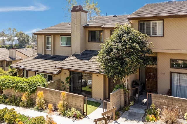 2506 Woodlands Way, Oceanside, CA 92054 - townhome / multi-family property featuring a chimney, a tiled roof, and fence