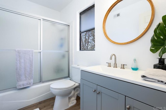 2506 Woodlands Way, Oceanside, CA 92054 - bathroom featuring wood finished floors, toilet, vanity, and shower / bath combination with glass door