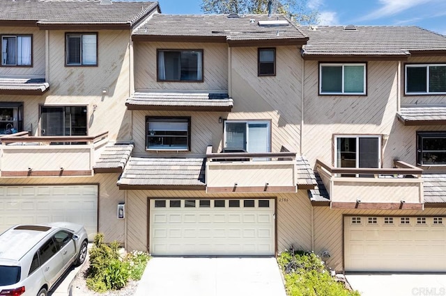2506 Woodlands Way, Oceanside, CA 92054 - rear view of property with an attached garage, a balcony, and concrete driveway