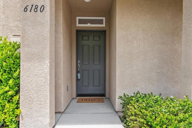view of exterior entry with stucco siding
