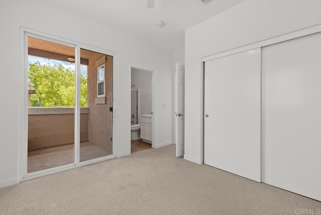 unfurnished bedroom with carpet floors, ensuite bathroom, a closet, and ceiling fan