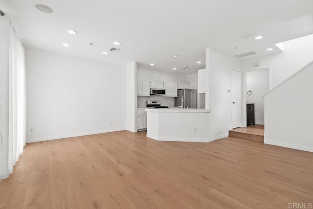 6180 Citracado Cir, Carlsbad, CA 92009 - unfurnished living room with light wood finished floors and recessed lighting