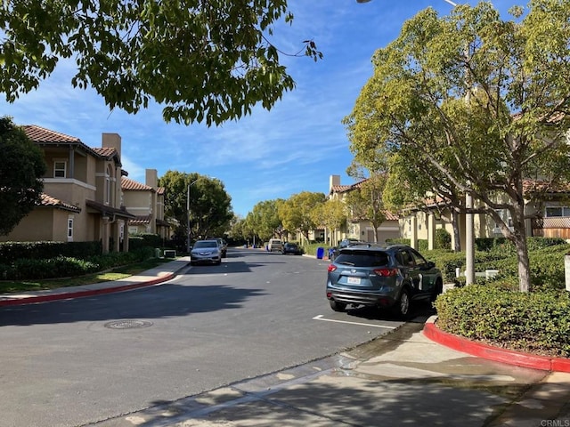 6180 Citracado Cir, Carlsbad, CA 92009 - view of asphalt road featuring curbs, sidewalks, and a residential view