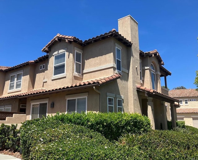 6180 Citracado Cir, Carlsbad, CA 92009 - rear view of house featuring a tile roof, stucco siding, and a chimney