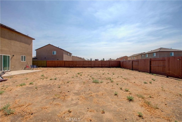 2045 Conadria Ave, Chowchilla, CA 93610 - fenced backyard with a patio area