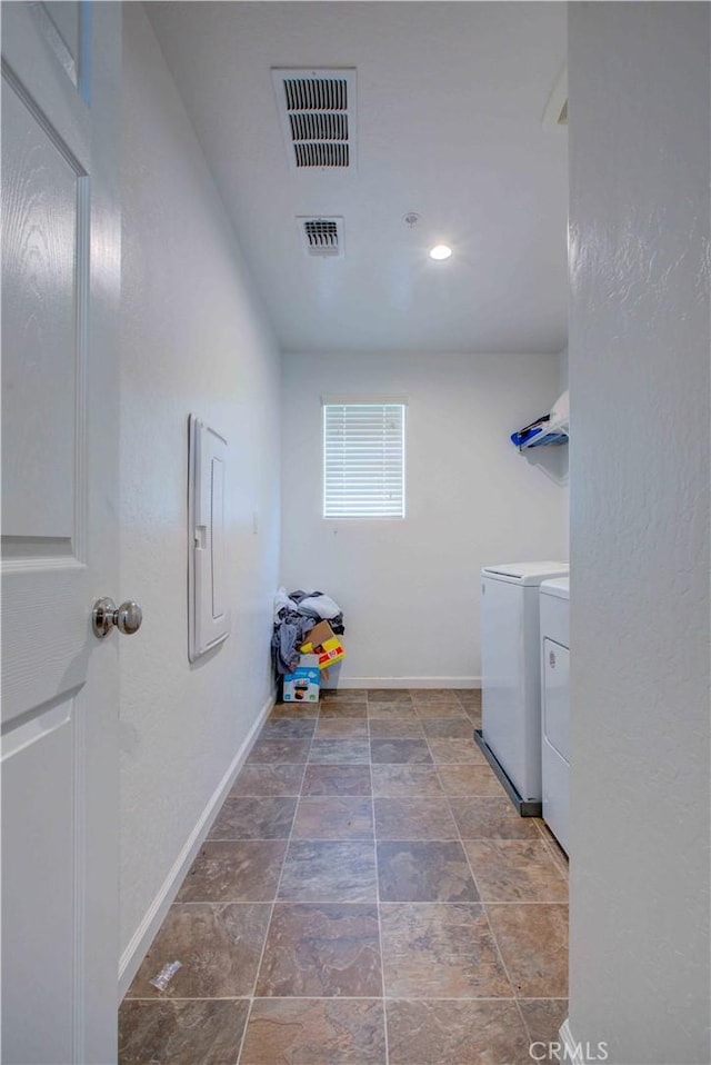 2045 Conadria Ave, Chowchilla, CA 93610 - washroom featuring washing machine and dryer, baseboards, electric panel, and stone finish flooring