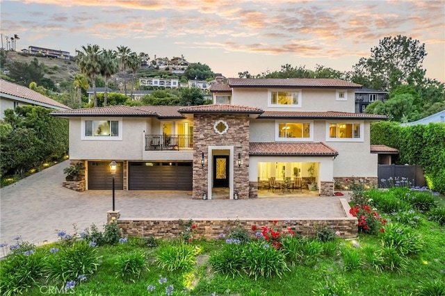 19151 Fowler Ave, North Tustin, CA 92705 - back of property with a balcony, stucco siding, an attached garage, stone siding, and decorative driveway