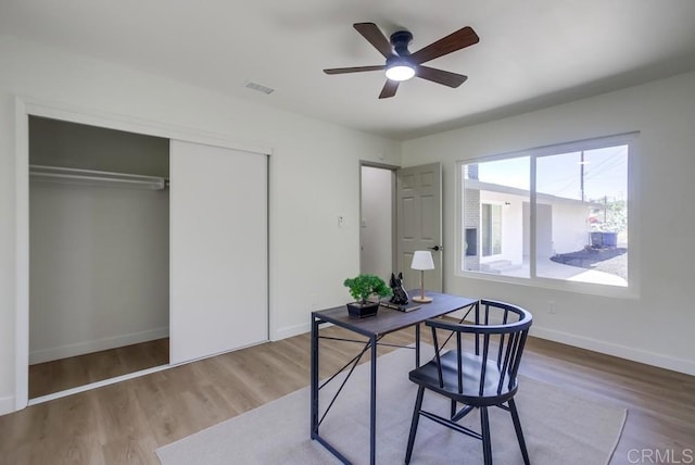 office area featuring ceiling fan, baseboards, and wood finished floors