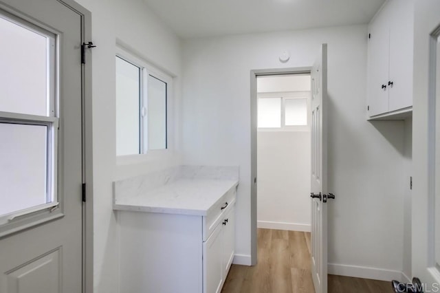 washroom with light wood-style floors and baseboards