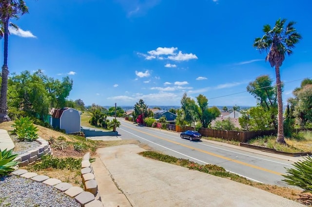 view of asphalt road featuring sidewalks