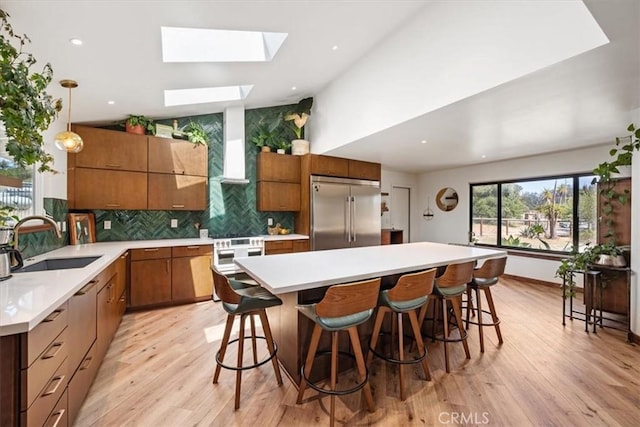 636 Jameson, Arroyo Grande, CA 93420 - kitchen with premium appliances, a sink, a skylight, light wood-type flooring, and recessed lighting
