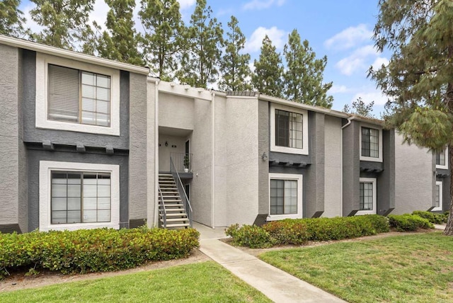 14936 Avenida Venusto Unit 12, San Diego, CA 92128 - view of property with stucco siding, stairway, and a front lawn