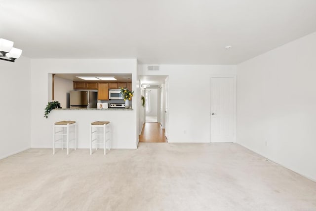 14936 Avenida Venusto Unit 12, San Diego, CA 92128 - unfurnished living room featuring light carpet