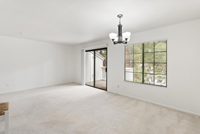 14936 Avenida Venusto Unit 12, San Diego, CA 92128 - unfurnished room with a chandelier, light carpet, and baseboards