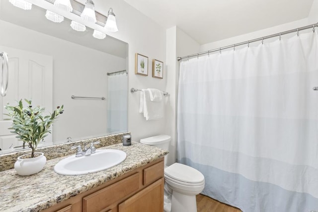 14936 Avenida Venusto Unit 12, San Diego, CA 92128 - bathroom with toilet, vanity, and wood finished floors