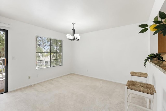 14936 Avenida Venusto Unit 12, San Diego, CA 92128 - unfurnished room featuring a chandelier, light carpet, and baseboards
