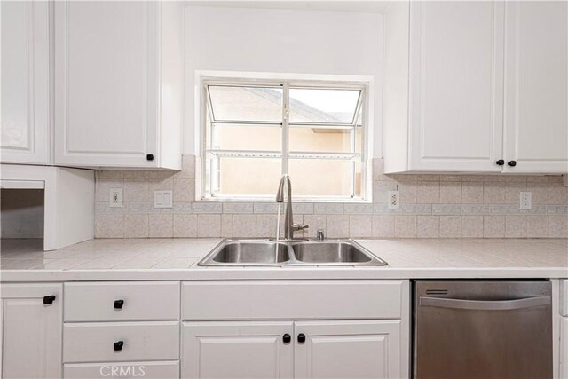 15821 Willett Ln, Huntington Beach, CA 92647 - kitchen featuring dishwasher, a sink, white cabinetry, and backsplash