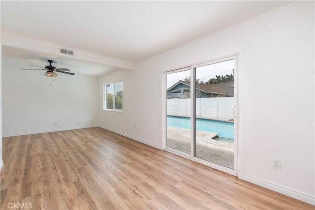 15821 Willett Ln, Huntington Beach, CA 92647 - spare room featuring light wood-style flooring, ceiling fan, and baseboards